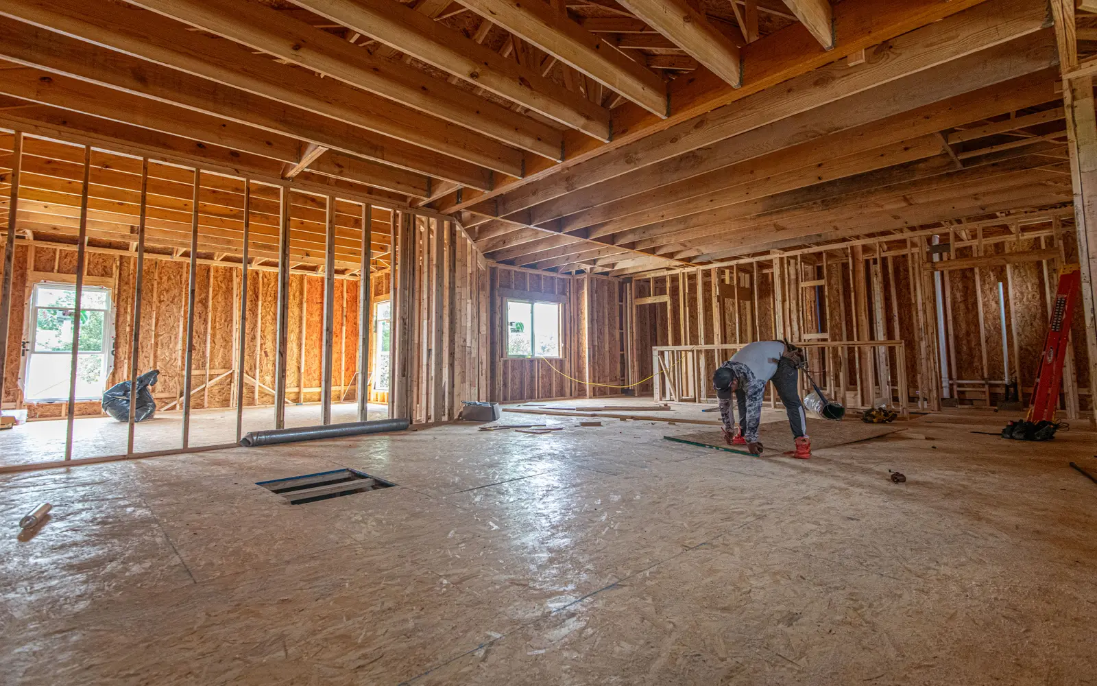 Framed interior of a house under construction, the kind of project every contractor type on this page builds